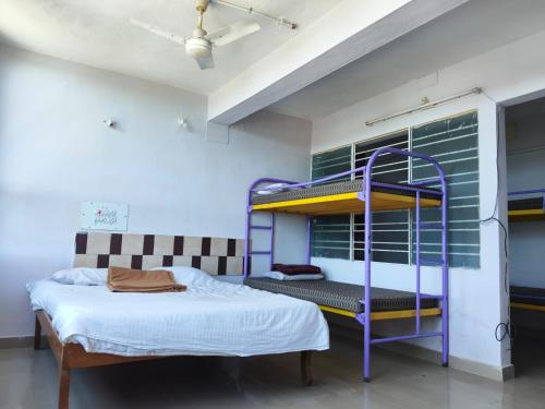 a bedroom with a purple bunk bed in a room at VISHAKA RESIDENCY yercaud in Siddhma