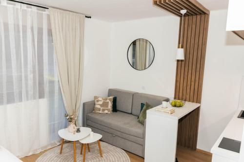a living room with a couch and a table at Lorena 21 Central in Bileća