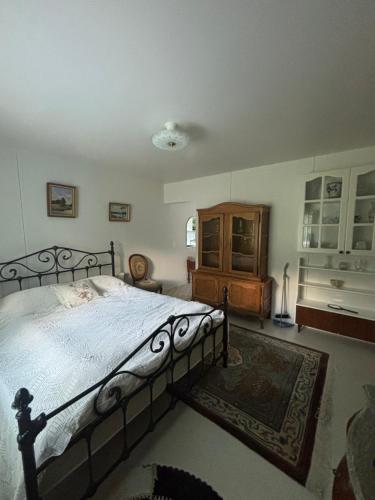 a bedroom with a large bed and a wooden cabinet at Studio Sillankorva in Viitasaari