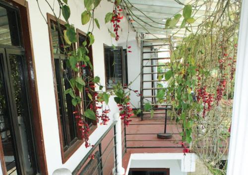 a house with flowers on the front porch at Sanara Hotel in Nuwara Eliya