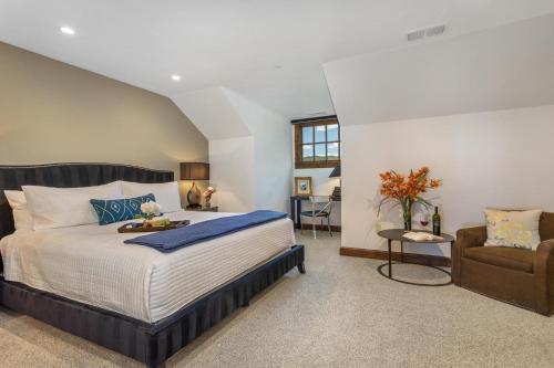 a bedroom with a large bed and a chair at 406 The Ascent in Avon