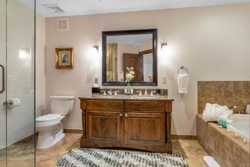 a bathroom with a sink and a toilet and a mirror at 406 The Ascent in Avon