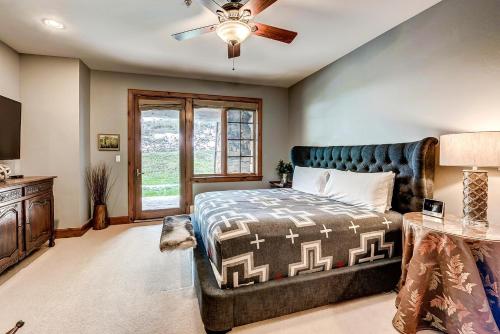 a bedroom with a bed and a ceiling fan at 205 Bear Paw Lodge in Avon