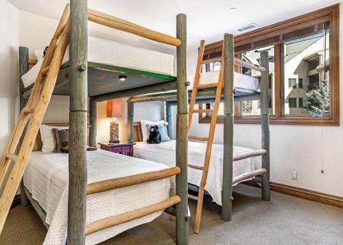 two bunk beds in a room with a window at 323 Beaver Creek Lodge in Avon
