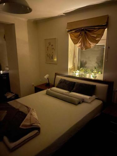 a bedroom with a large bed with a window at Maria's Studios Rent Peplos in Péplos