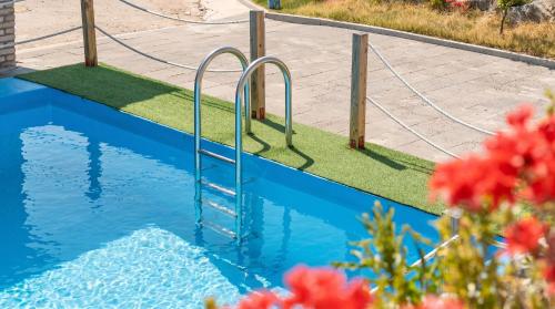 a swimming pool with a ladder in the water at Ganghwa Glory Bada Pension in Incheon