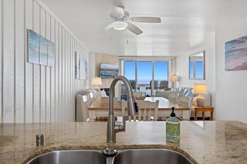 a kitchen sink with a view of a dining room at D20 - Beachfront Delight in Oceanside
