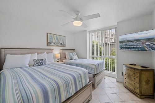 a bedroom with two beds and a window at D20 - Beachfront Delight in Oceanside