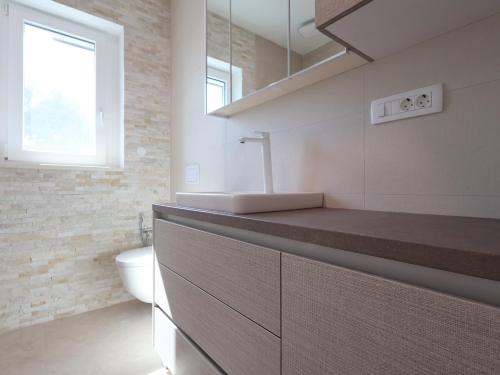 a bathroom with a sink and a toilet at Airport Split in Kastel Stafilic