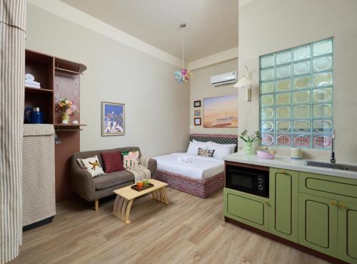 a small living room with a couch and a table at LangX Chapter Hotel & Apartment in Danang