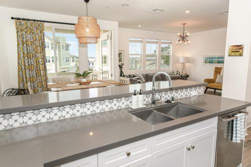 a kitchen with a sink and a large window at Sea Glass Villa in Oceanside