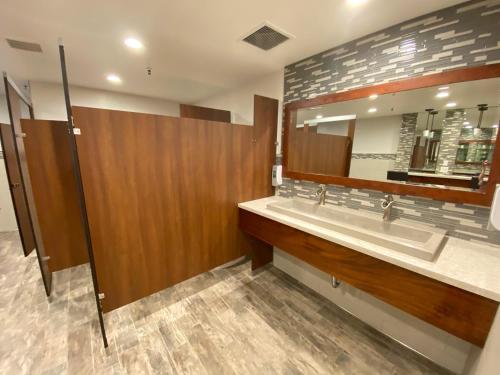 a bathroom with a sink and a mirror at D2 - Breakwater Bungalow in Oceanside