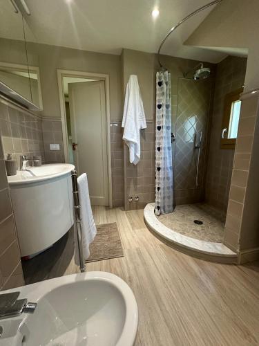 a bathroom with a shower and a sink and a tub at Spacious e Modern Comfort Near Center in Lucca