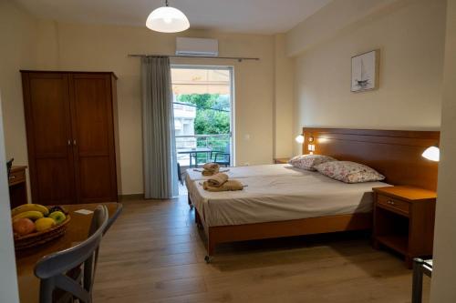 a bedroom with a bed with a teddy bear on it at TRIANTAFYLLOY ROOMS in Loutra Edipsou