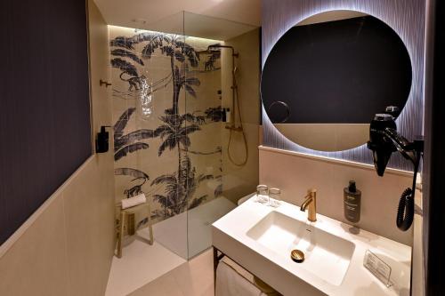 a bathroom with a sink and a shower at Sercotel Sevilla Don Luciano in Seville