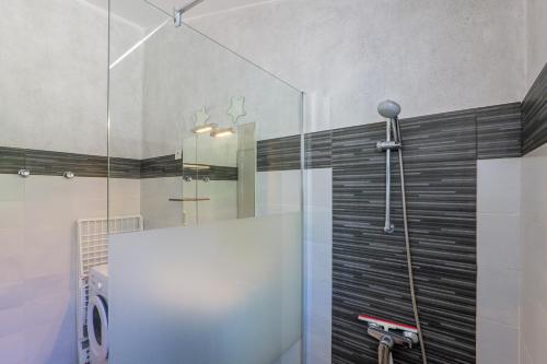 a shower with a glass door in a bathroom at Le Peuplier - La Fontinelle in Bessas