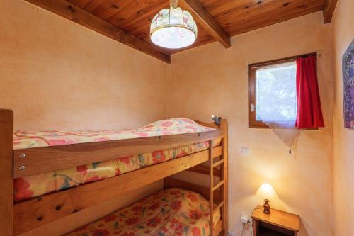 a bedroom with two bunk beds and a window at Le Peuplier - La Fontinelle in Bessas