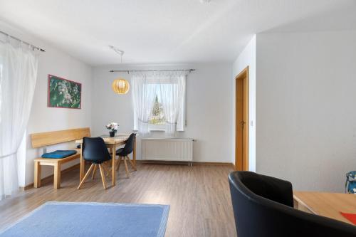 a living room with a table and chairs at Apartment 44 in Bad Dürrheim