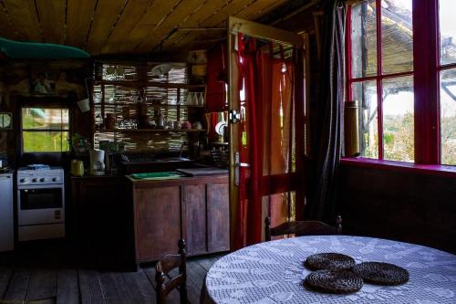 a kitchen with a table and a kitchen with a table and a tableablish at Cabane Layénie sous les étoiles in Bajamont