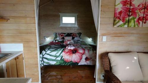 a small room with a bed with flowers on it at Red Hibiscus Villas in Rarotonga