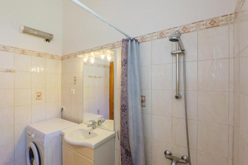 a bathroom with a sink and a toilet and a shower at Le Micocoulier - La Fontinelle in Bessas