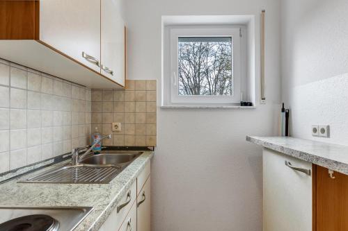 a kitchen with a sink and a window at Apartment 47 in Bad Dürrheim