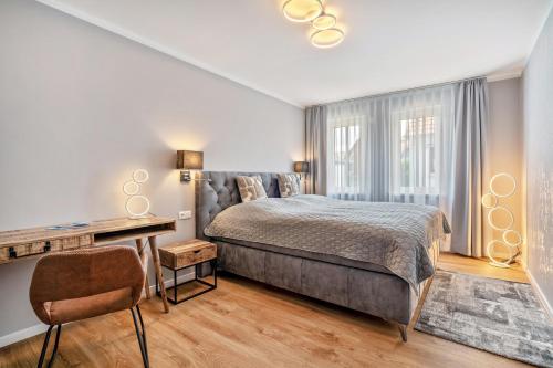a bedroom with a bed and a desk and a window at Haus am See in Malchow