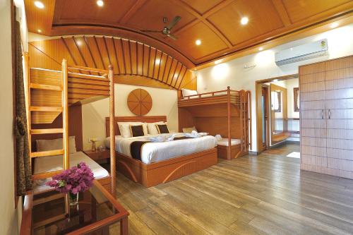 a bedroom with two bunk beds and a staircase at Singaras Coffee Country in Masinagudi