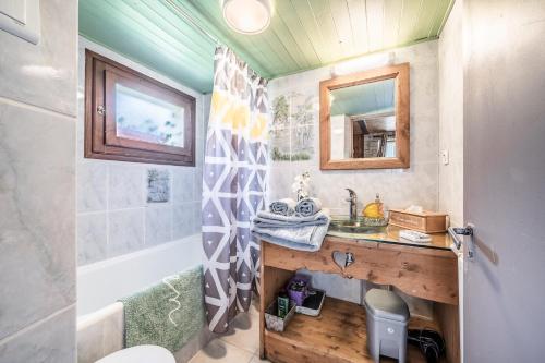 a bathroom with a sink and a shower at Maison De La Coutettaz in Morzine