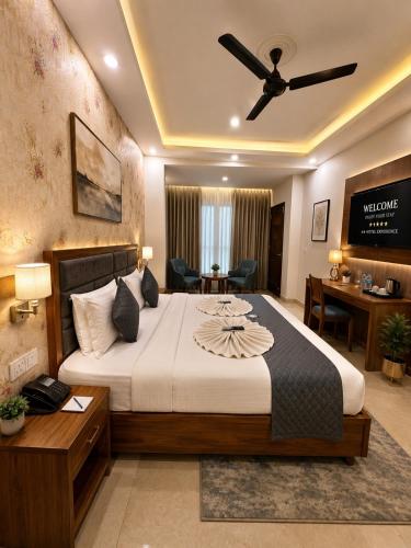 a bedroom with a large bed with a ceiling fan at Frolic Hotel Near Sec 52 Noida Metro Station in Noida