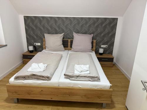 a bed with two pillows on it in a room at Casa del Mondo 4 in Sankt Aldegund
