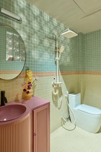 a bathroom with a shower and a sink and a toilet at LangX Chapter Hotel & Apartment in Danang