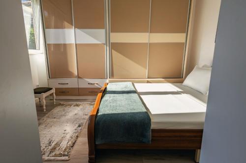 a small bedroom with a bed and a window at G's Place in Prishtinë