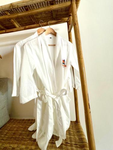 a white shirt is hanging on a bed at The Sanctuary in El Nido