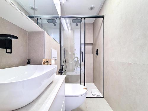 a bathroom with a white tub and a toilet at La Llana Beach MDC - 8010 in Mar de Cristal