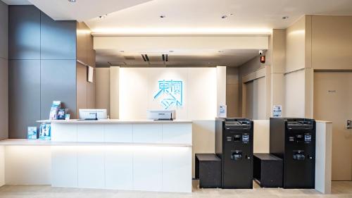 a store with two refrigerators on display in a room at Toyoko Inn Kitakami-eki Nishi-guchi in Kitakami