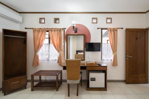 a room with a desk and a mirror at Cove Rumah Asri in Bandung