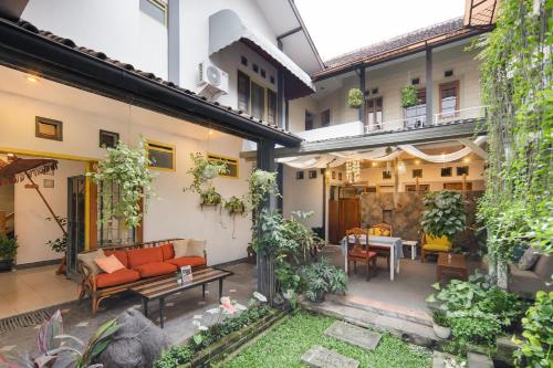 an outdoor patio with a couch and a table at Cove Rumah Asri in Bandung