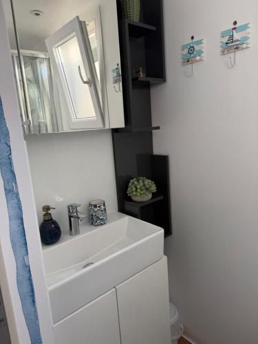 a bathroom with a white sink and a mirror at Dolce Vita in Drage