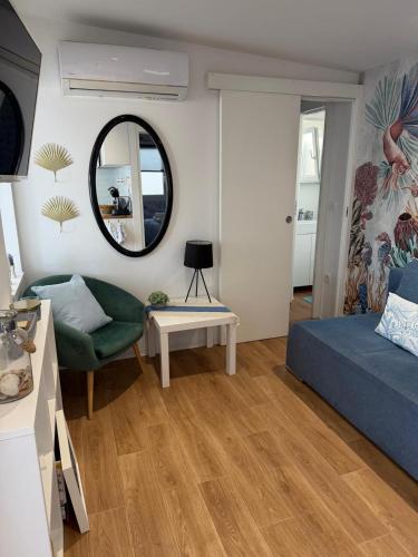 a living room with a bed and a mirror at Dolce Vita in Drage