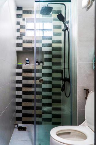 a bathroom with a glass shower with a toilet at LUNA House in Can Tho