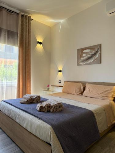 a bedroom with a bed with two towels on it at B&B Magiulsà in Siniscola