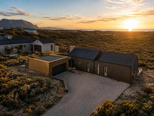 an aerial view of a house in the desert at sunset at 401 Kingfisher in Gansbaai