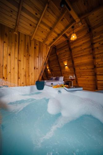 a jacuzzi tub in a room with wooden walls at Dedeman Village Sapanca in Sakarya