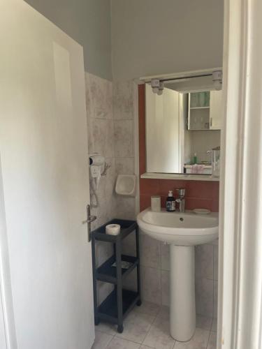 a bathroom with a sink and a mirror at Thalassa apartments in Marathias