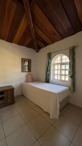 a bedroom with a bed and a window at Curlt stays in Kampala