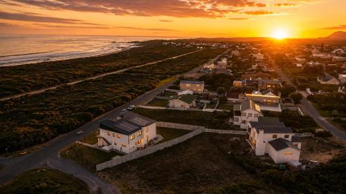 an aerial view of a residential neighborhood at sunset at Sea Mist Villa in Pearly Beach