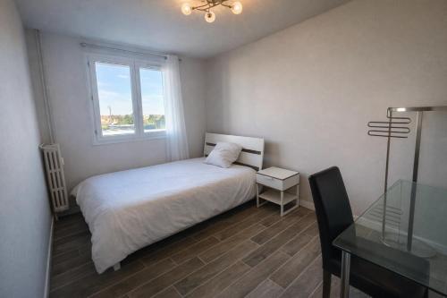 a bedroom with a bed and a window and a glass table at Chambre 3 privée lit double Béthune centre in Béthune