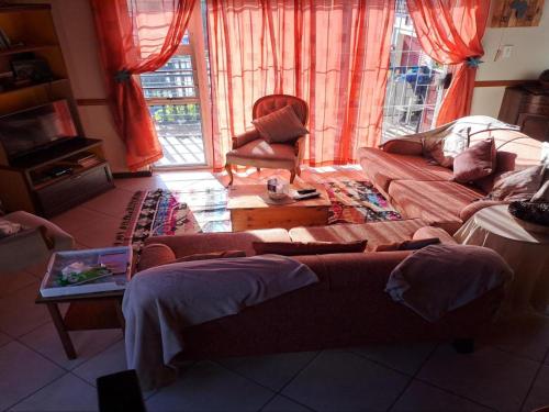 a living room with a couch and a table at A1Bay View Guest House Cottage & Apartment SEA FACING in Jeffreys Bay