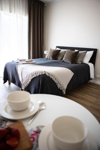 a bedroom with a bed and a table with dishes on it at Järvevaatega studio apartment in Viljandi